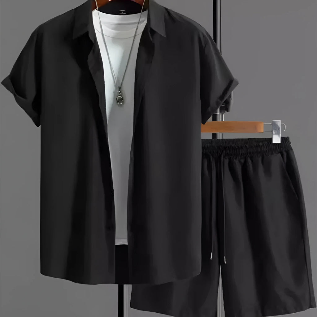 Man wearing a black and white jacquard patterned short sleeve suit shirt with matching formal shorts.