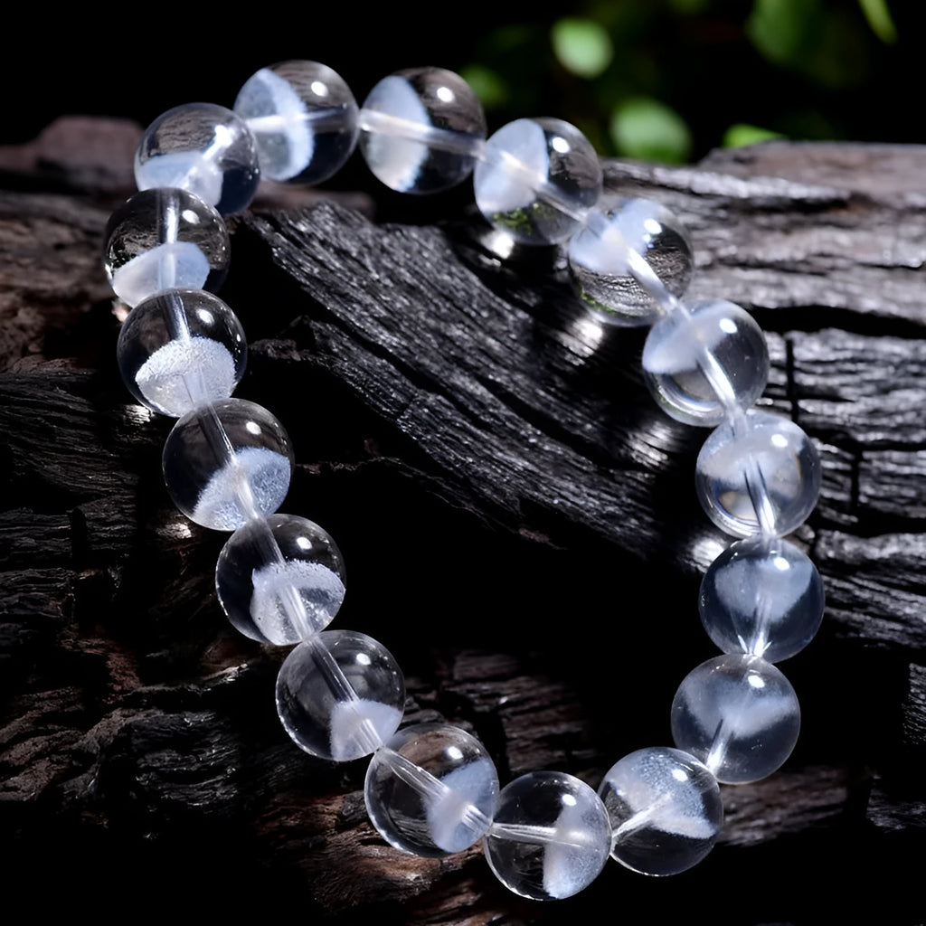 Women's natural white crystal bracelet with a pyramid charm and ruyi charm, showing spherical beads.