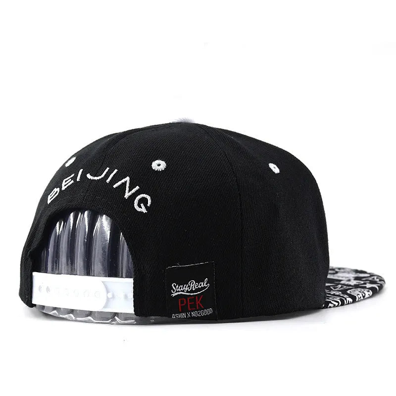 Adjustable black cotton baseball cap with embroidered lettering on the front, showing dome crown shape.