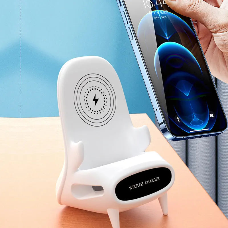 White mini chair-shaped wireless charging stand holding a mobile phone at an angle.