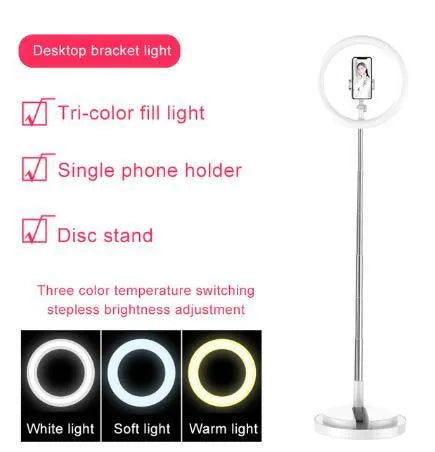 Portable 290mm LED selfie ring light in black on table, showing centre phone holder and adjustable brightness button