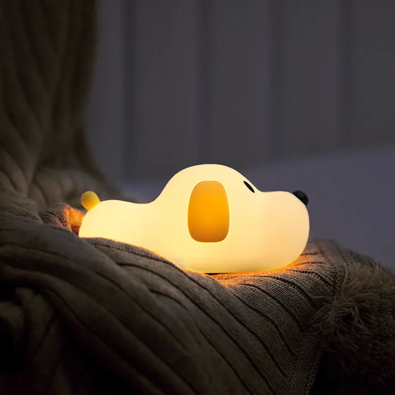 Dull Wang rechargeable silicone touch dimmable night light on a bedside table showing warm white glow