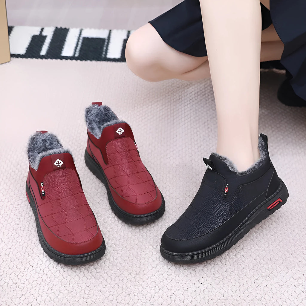 Women's black casual flat ankle boots with a synthetic leather upper and rubber sole.