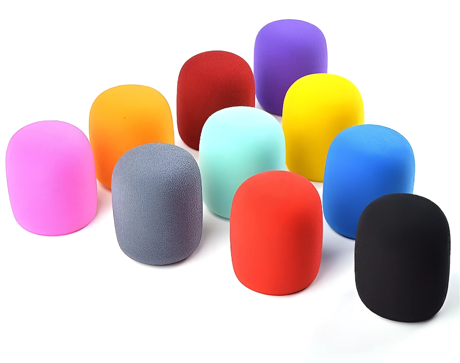 Four multicolored foam microphone windshields for handheld stage microphones on a grey background.
