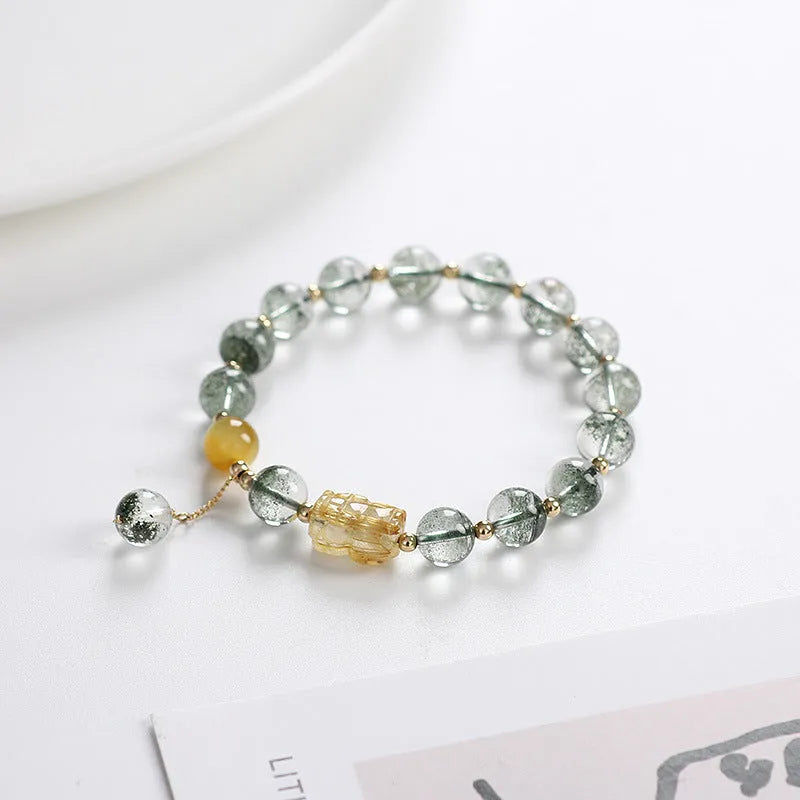 Green phantom quartz crystal bracelet with geometric design and gold rutile accents