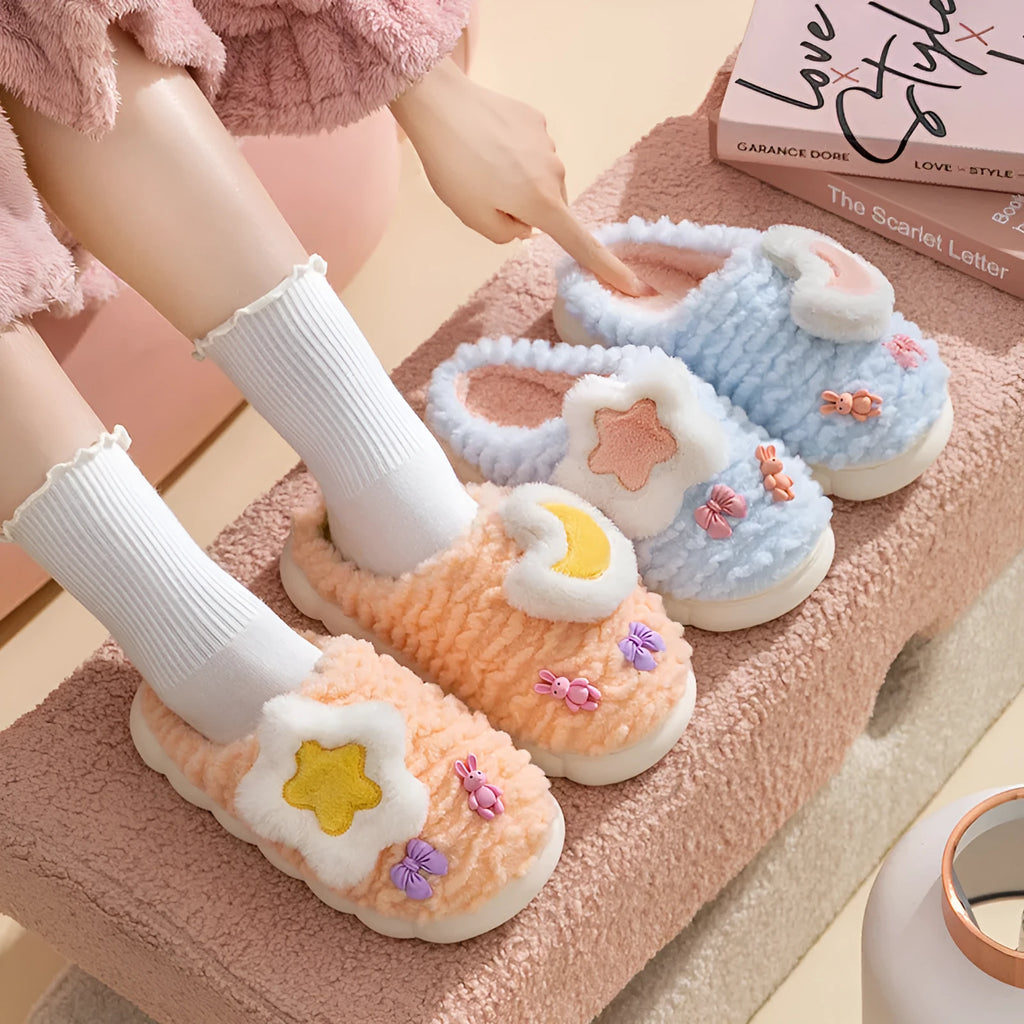 Light blue women's plush slippers with an animal pattern on the round toe holder and a thick fleece lining.