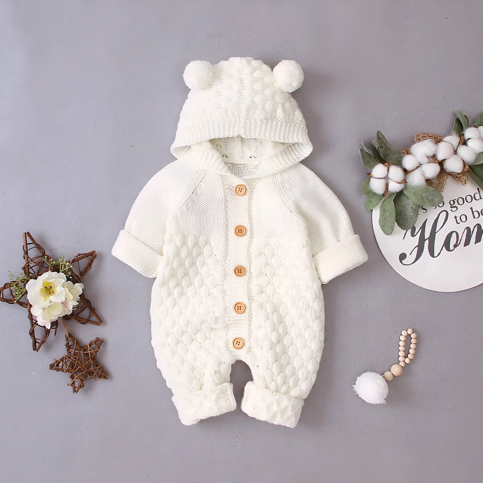 Baby knitted jumpsuit in blue, full-length with button front and hand flaps