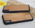 Wooden iPhone case with carbonised bamboo back and black TPU bumper on an iPhone.