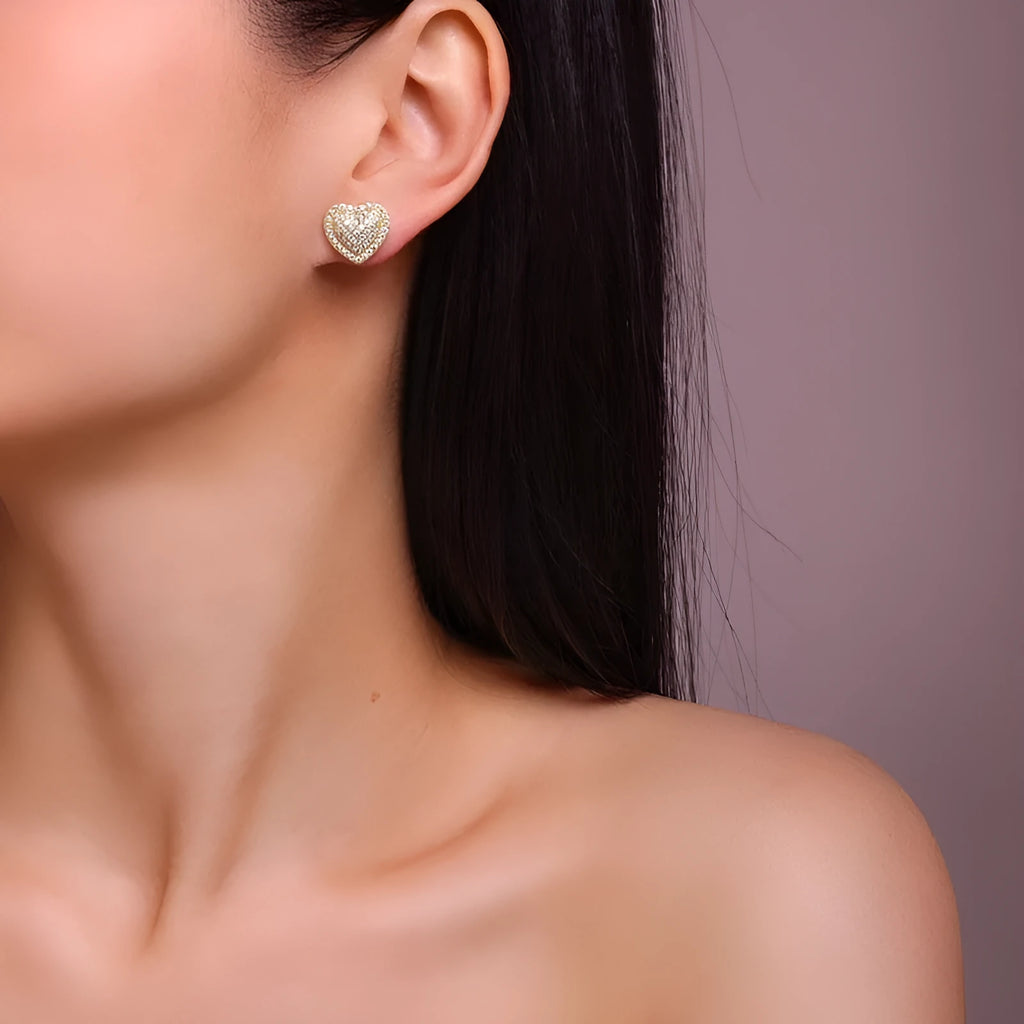 Gold and silver heart-shaped moissanite stud earrings with butterfly clutch fastenings