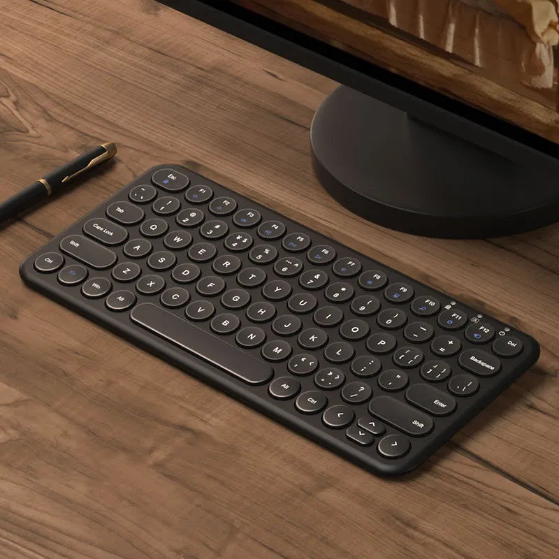 White ultra-thin wireless keyboard and mouse set with USB nano receiver on a wooden desk.