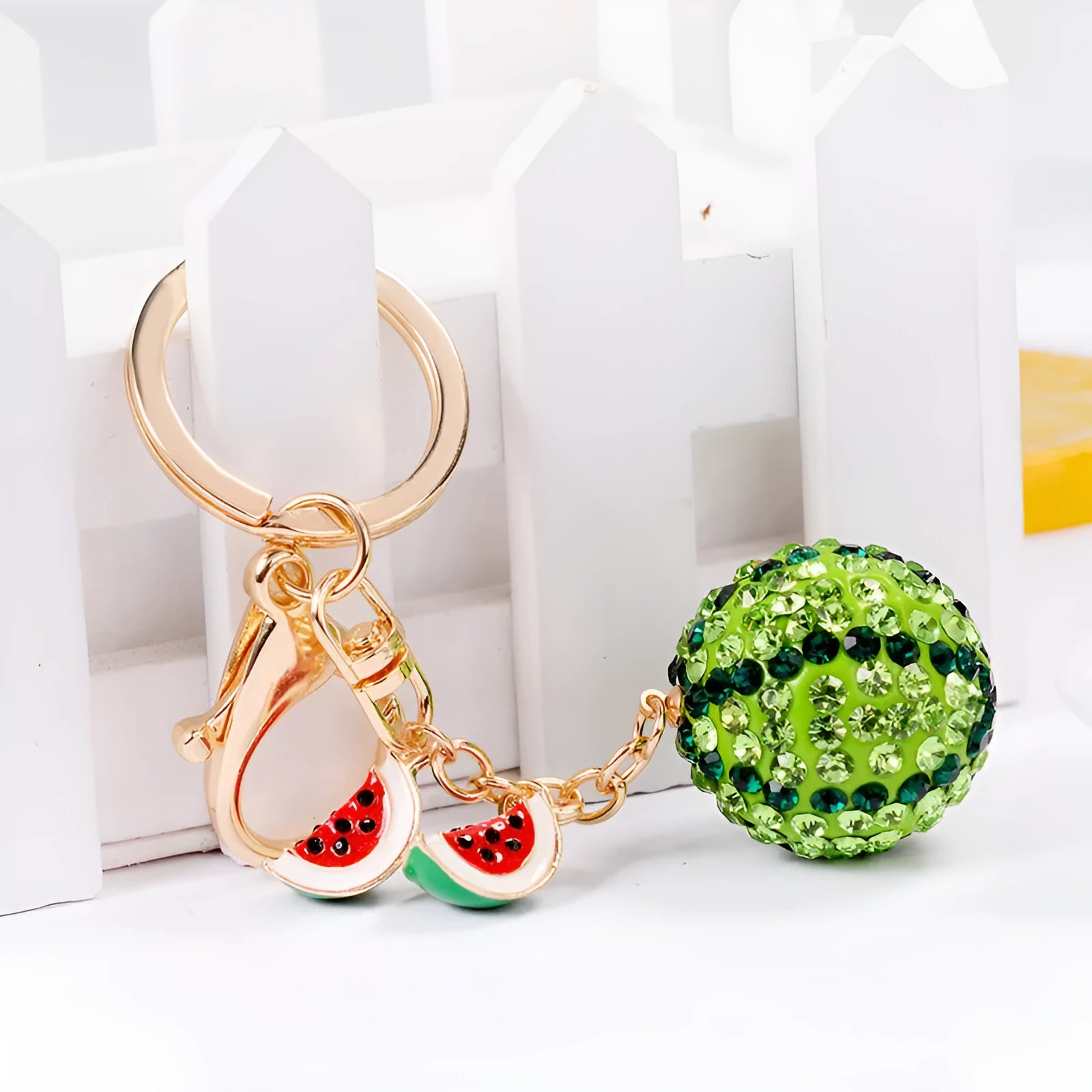 Green zinc alloy watermelon slice keychain measuring 12cm in length.