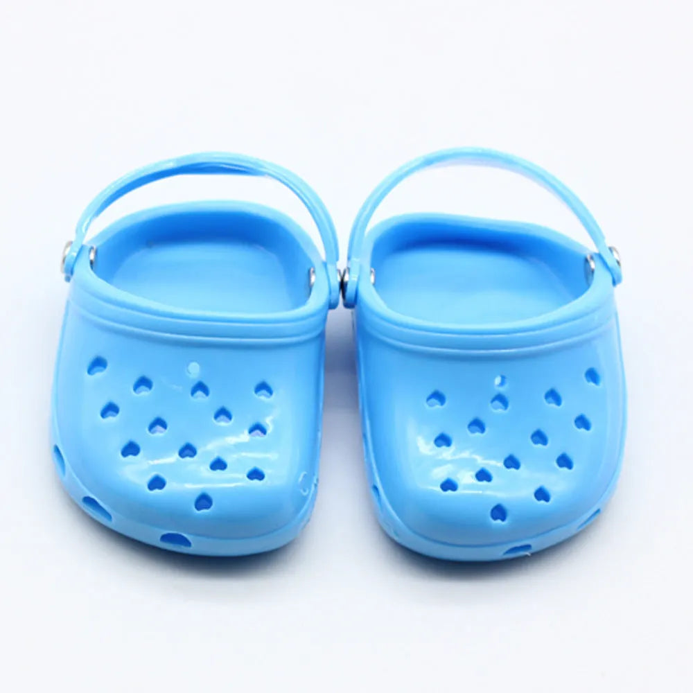 Set of small plastic doll beach slippers in blue, red, yellow, and green colours.