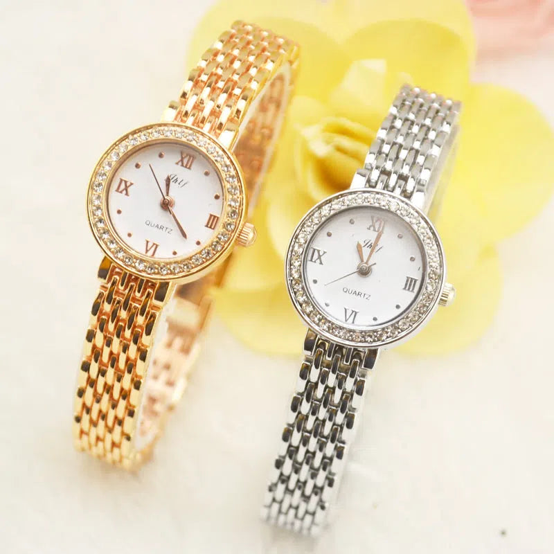 Gold alloy fashion quartz watch with rhinestone details, 20mm dial, and ordinary glass mirror on a neutral background
