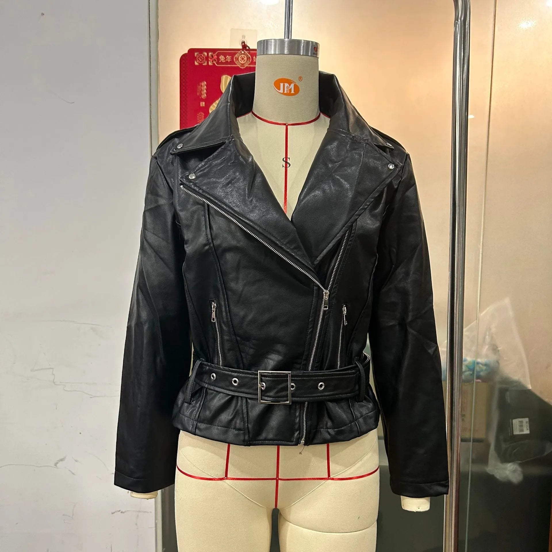 Black punk locomotive jacket with a round Peter Pan collar and a drawstring waist on a hanger.