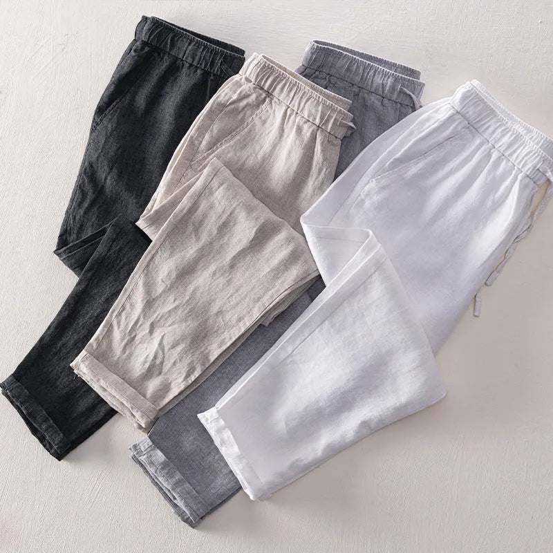 Men's straight leg linen trousers in light grey colour showing mid waist and relaxed fit