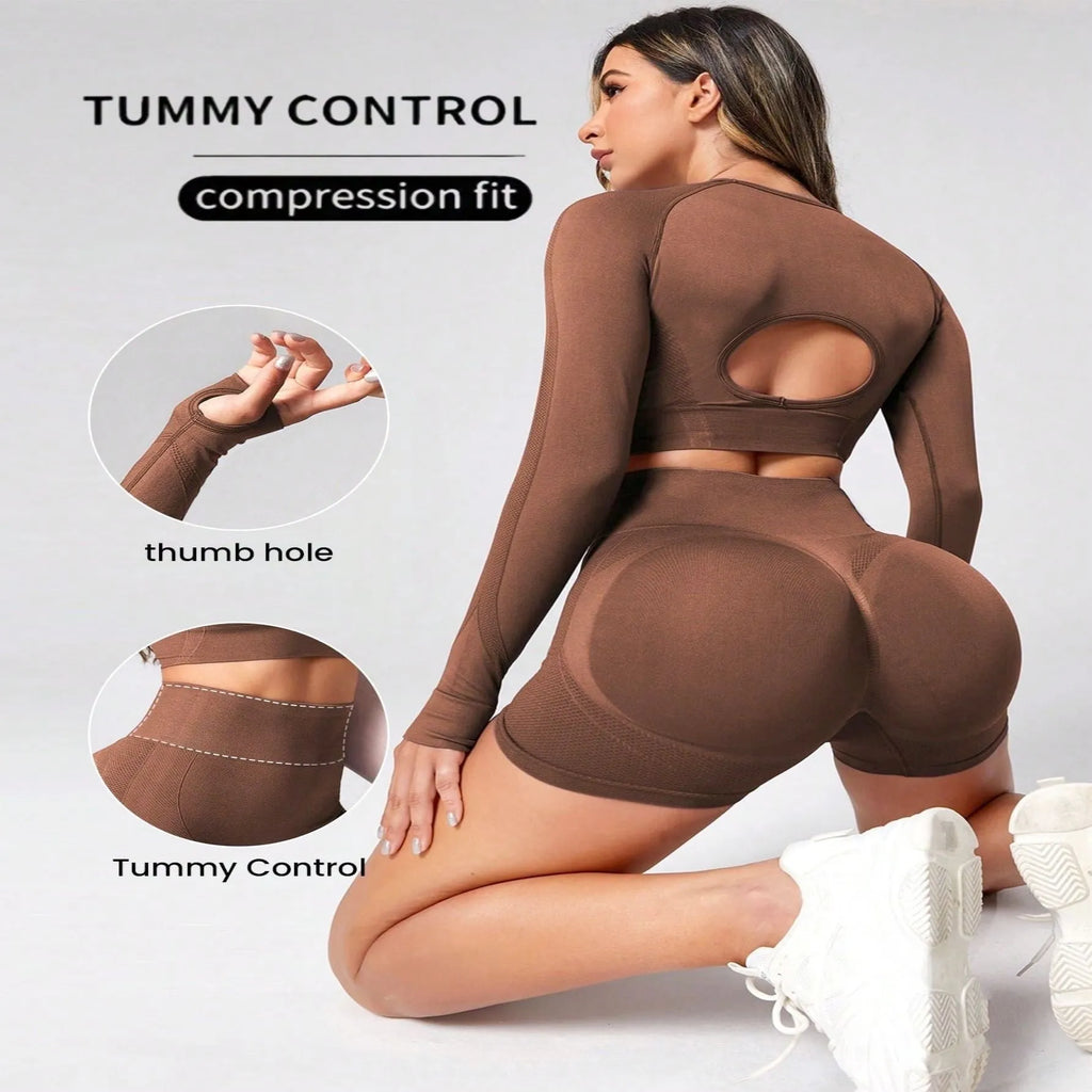 Women's black high-waist yoga pants and long-sleeve top set laid flat.