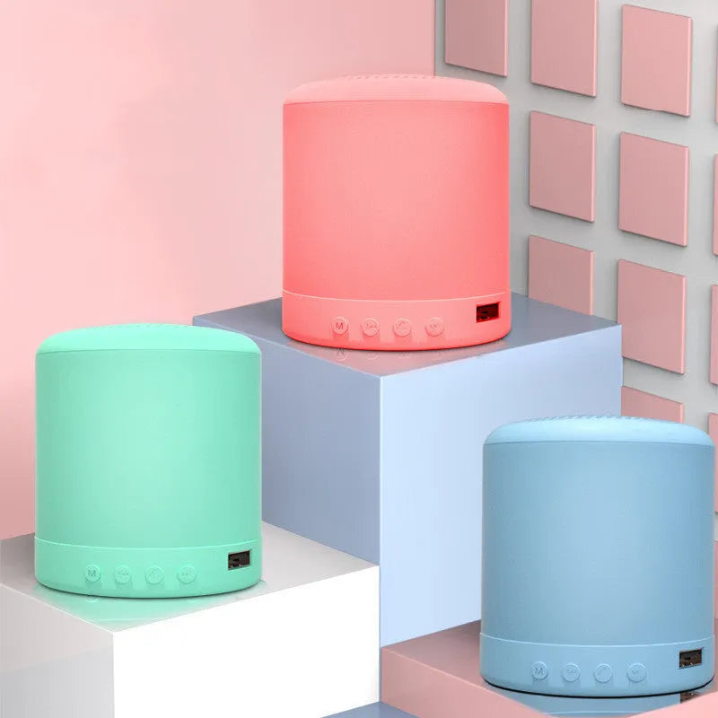 A11 compact cube wireless speaker in black, pink, blue, or green colour with multiple input ports.