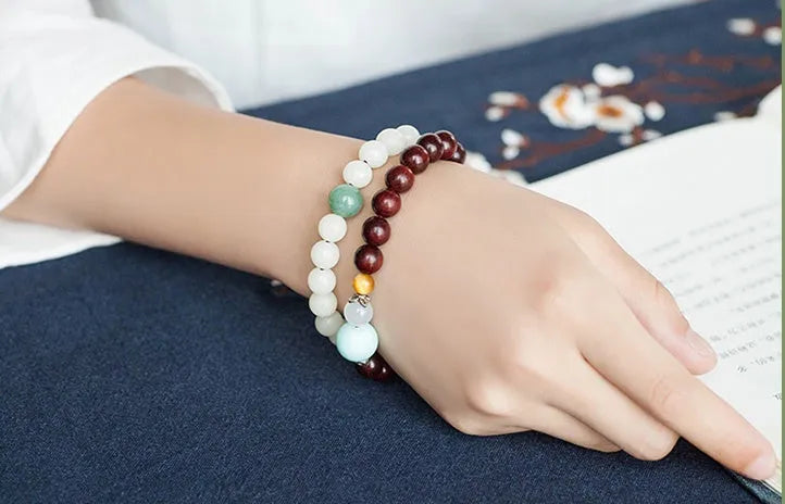 Natural white jade Bodhi bracelet with round beads and transfer bead on white background