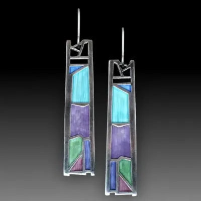 Silver-coloured women's earrings in a water drop shape with an irregular, textured edge design.