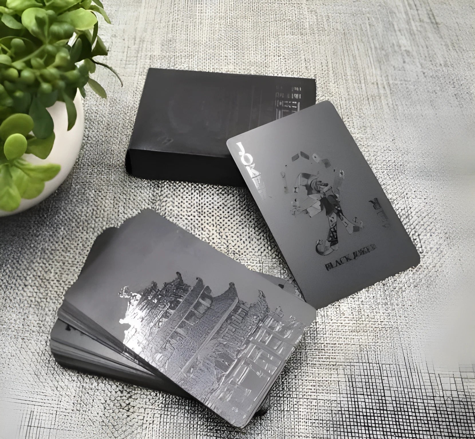 Black Diamond waterproof plastic poker cards with gold foil finish showing laser-etched diamond pattern on black background