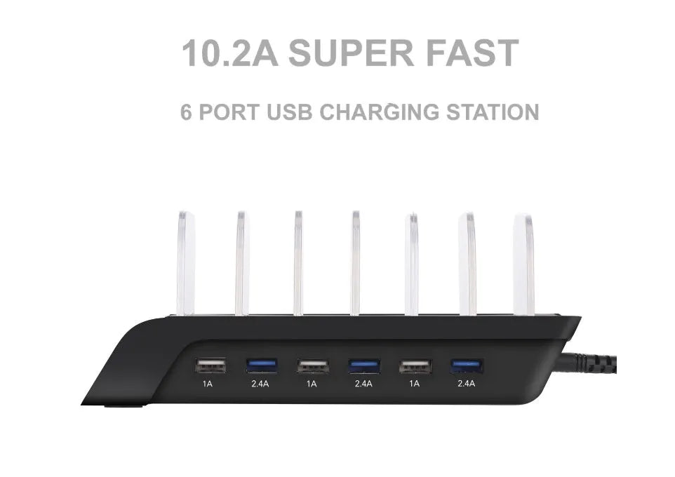 Six-port USB mobile phone charging stand in silver with multiple phones and tablets inserted, on a wooden desk