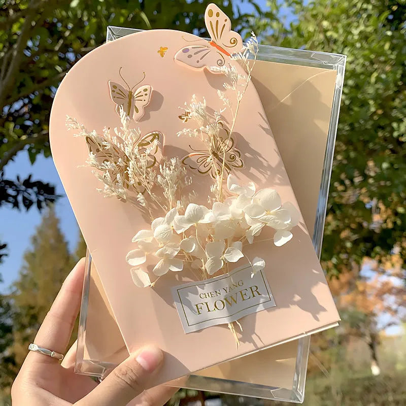 Handmade 3D boxed birthday card with butterfly shape and artificial flowers.