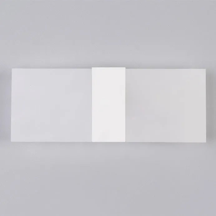 Modern acrylic wall-mounted LED bedside lamp in silver finish showing warm light illumination