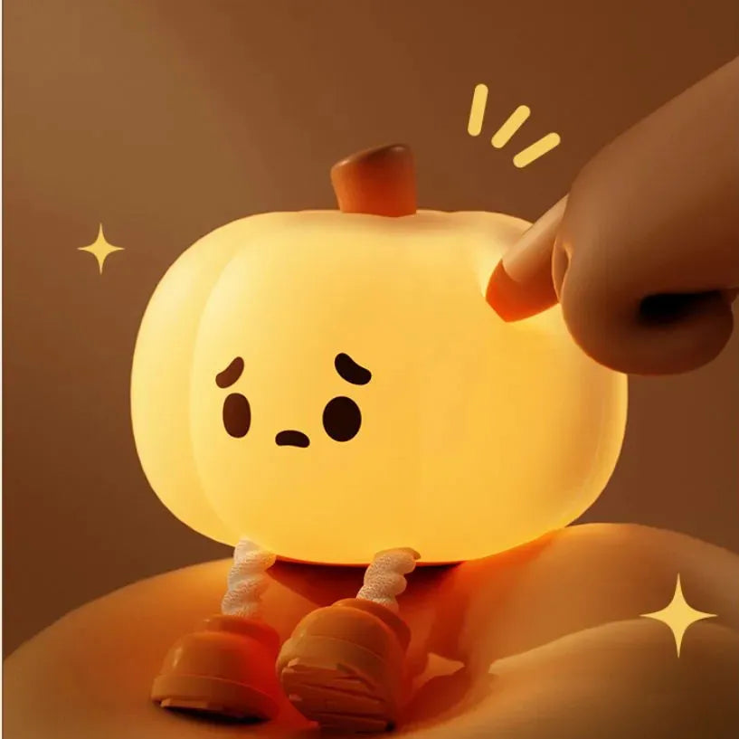 Soft silicone pumpkin night light with touch dimming controls and USB charging port