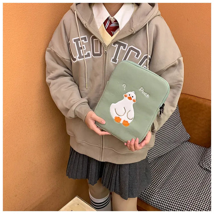 Blue cotton iPad case with embroidered cartoon duck design and a zipper.