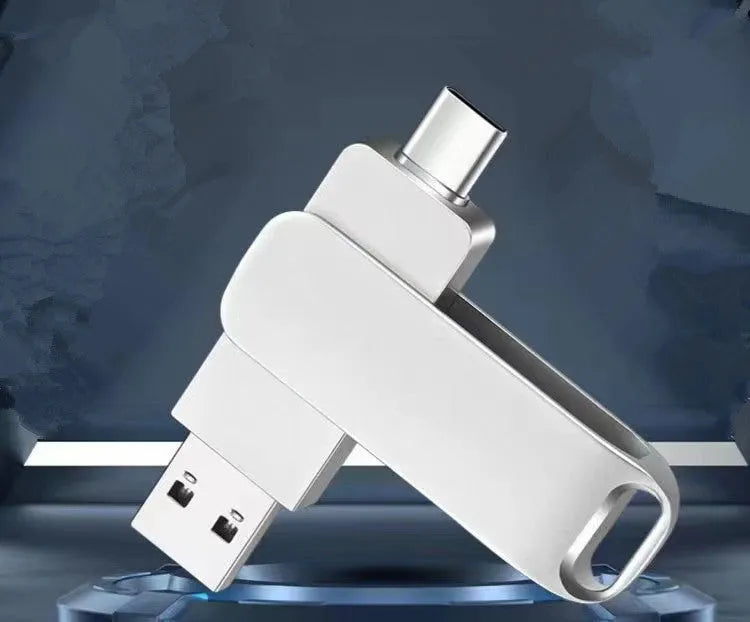 Rotating metal USB flash drive showing USB and USB-C connectors with black finish and protective iron box packaging