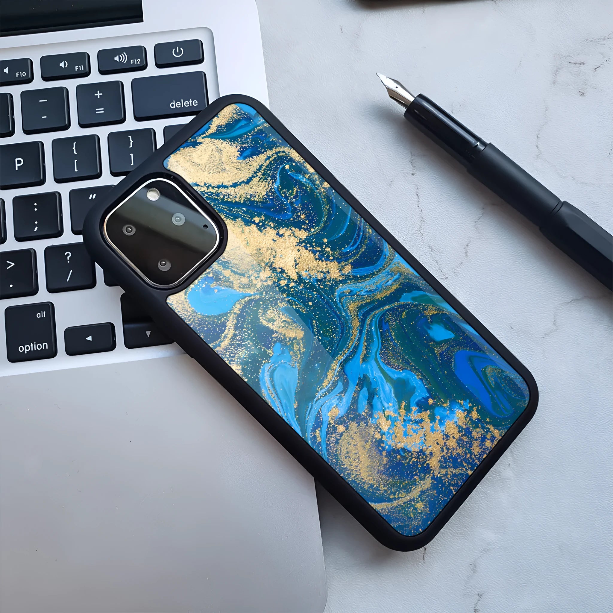Marble pattern plastic back cover case for iPhone, shown in a blue and gold colour variant.