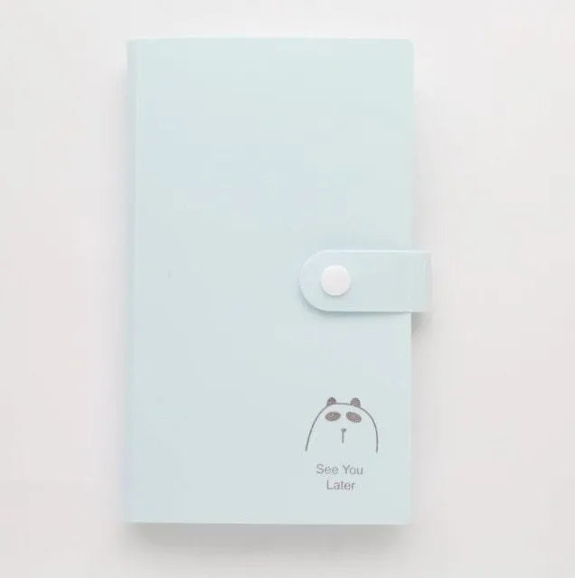 Blue PVC and PP business card holder book with protective shell, showing smile logo and insert slots.