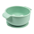Blue silicone pet bowl with a suction cup base on a smooth floor
