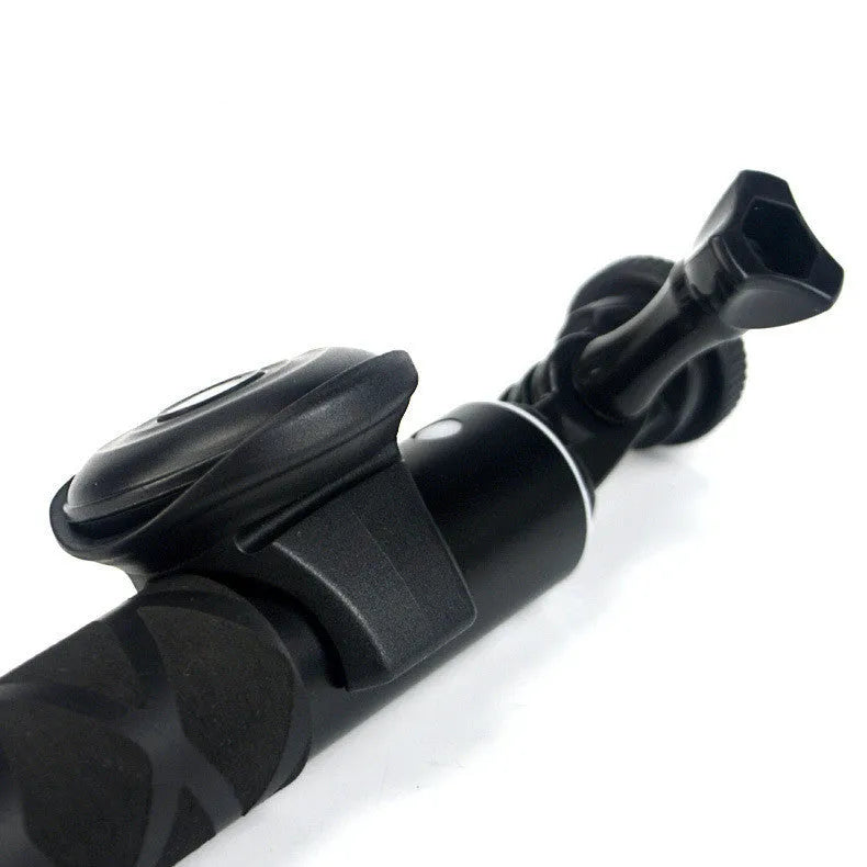 Small black Snap Bluetooth remote control for wireless smartphone camera photos on a white background.