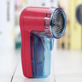 Portable electric lint remover device for removing pills from sweaters and fabrics
