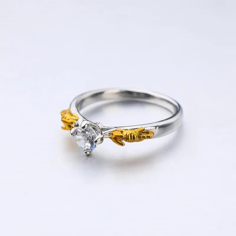 Detailed close-up of a black gold copper crown ring with a central crystal on a finger.