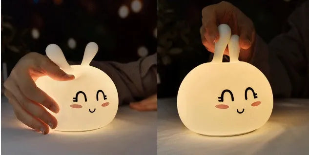 White marshmallow bunny LED night light with shy face or happy face option on a table.