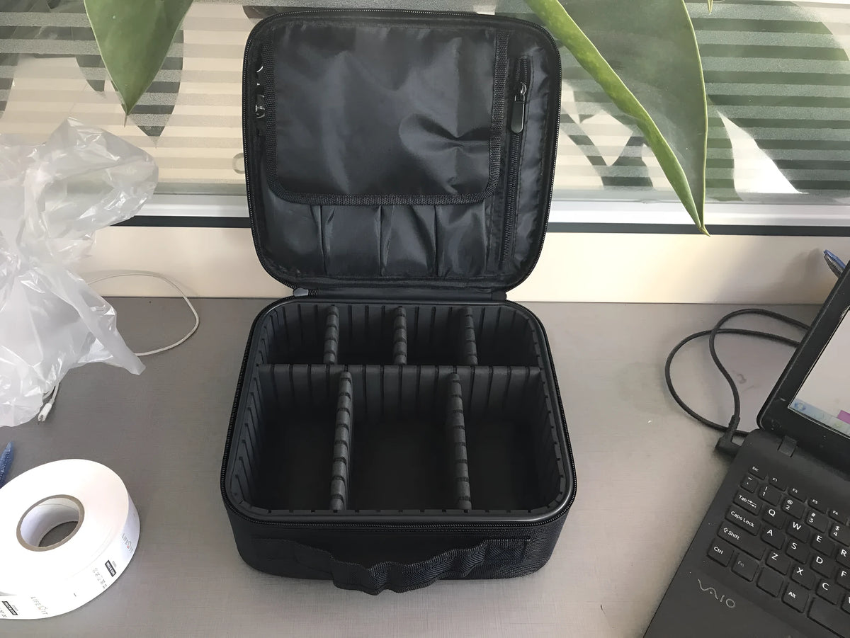 Mini black nylon cosmetic bag with zip closure, 26x22x12cm, shown open with make-up inside