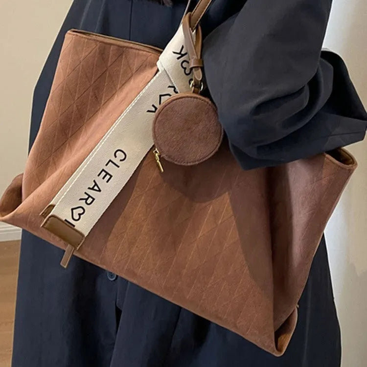 Large black polyester shoulder bag showing horizontal square shape and organisational pockets