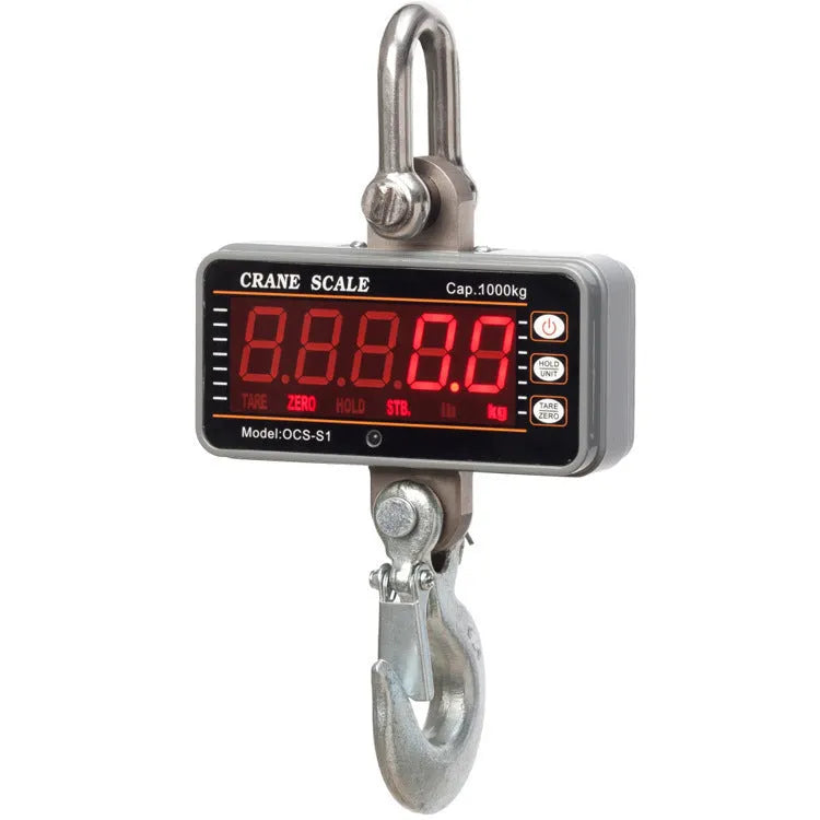 Orange electronic crane scale with digital display for 500 kg loads in warehouse.