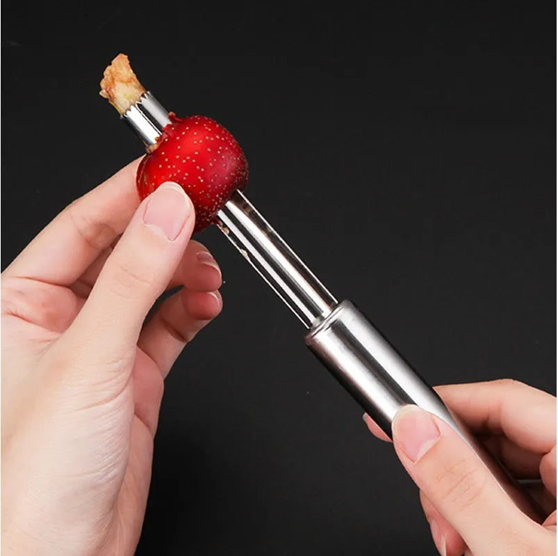 Stainless steel pineapple corer slicer with coloured ABS handle on a kitchen counter.