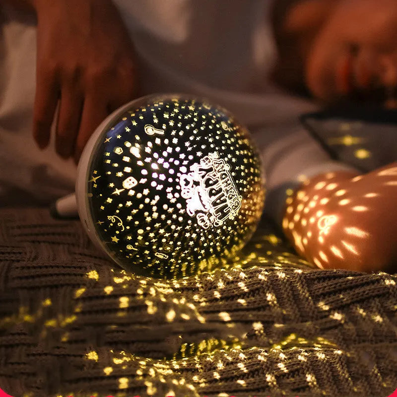 Rotating starlight projection lamp in black or white with cartoon style design and battery power