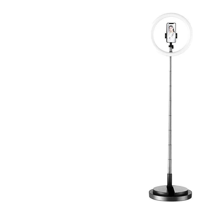 Portable 290mm LED selfie ring light in black on table, showing centre phone holder and adjustable brightness button