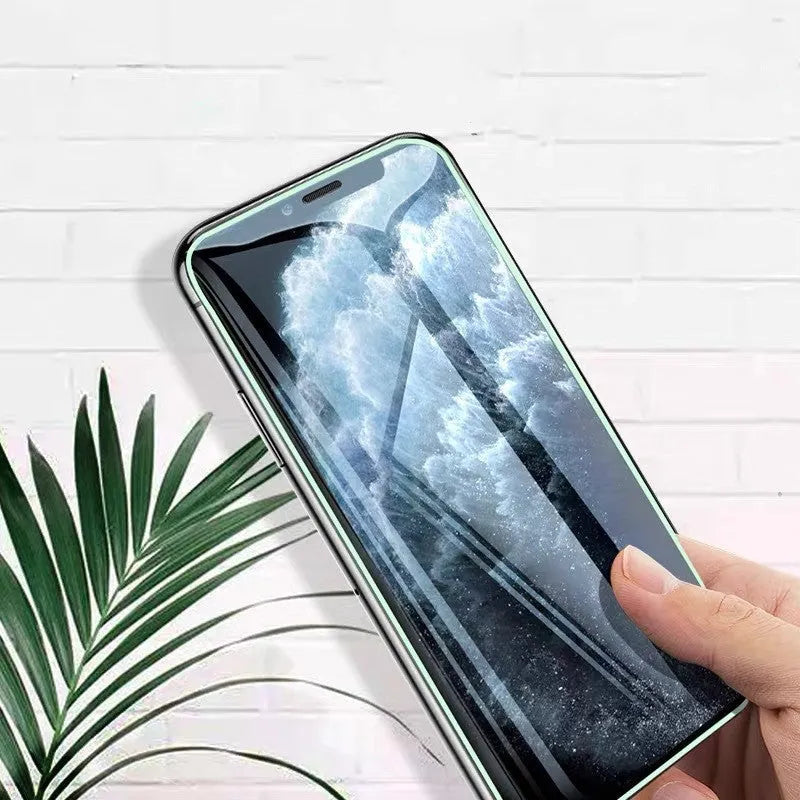 Luminous full cover tempered glass screen protector glowing softly next to an iPhone.