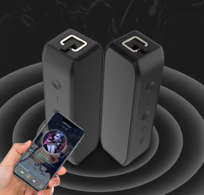 Black waterproof Bluetooth speaker with control buttons and multiple connection ports