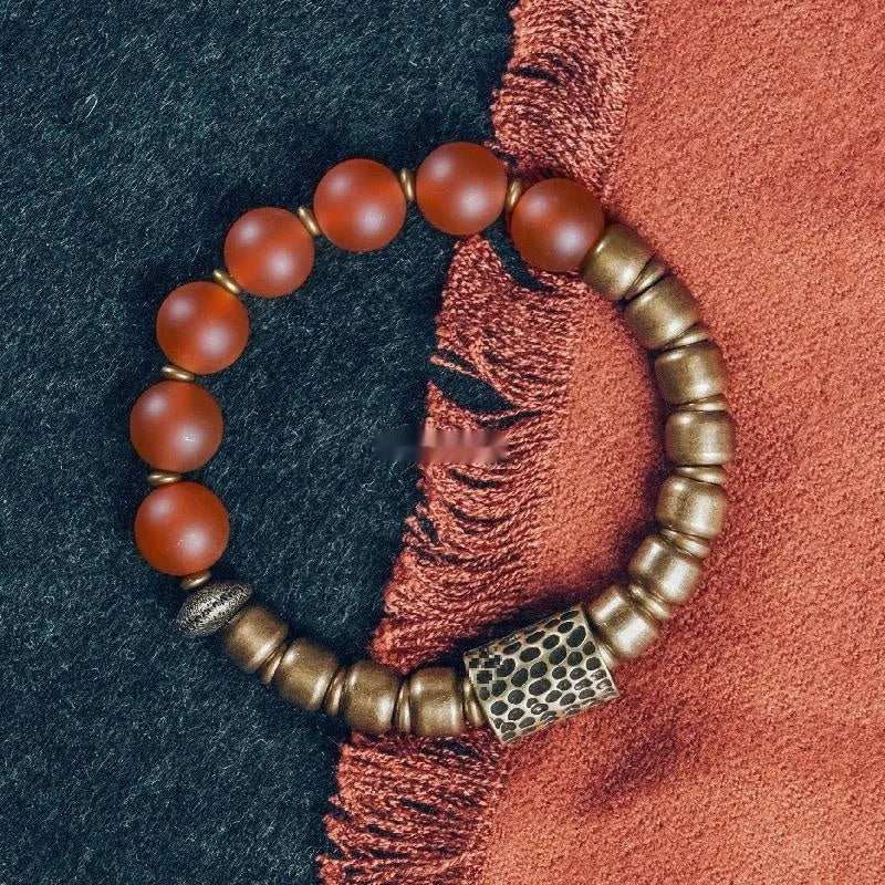 Retro ethnic style couples bracelet made from natural green agate beads on a wrist.