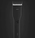 Black cordless men's hair clipper with ceramic blades and adjustable length comb