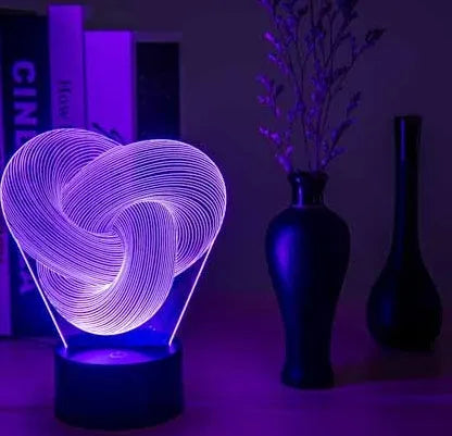 Twist abstract LED 3D night light in colour gradient mode on a wooden table with remote control