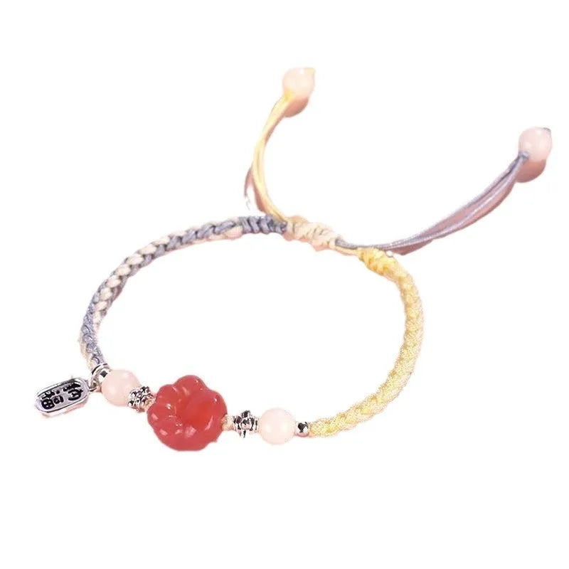Handmade glass cat paw couple bracelet with red charm on pink or yellow woven cord