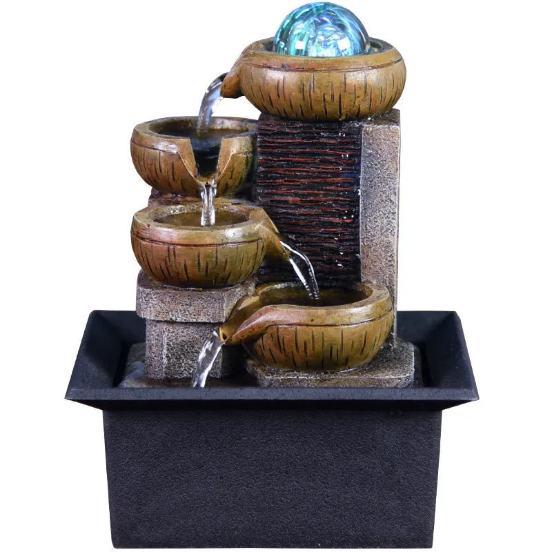 European desktop fountain with crystal ball and flowing water on a wooden desk